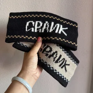 Detailed close-up of French jacquard knit headband with CRANK logo and wavy patterns