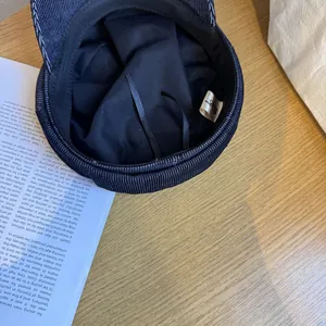Close-up of navy blue newsboy hat interior with twill texture and adjustable lining