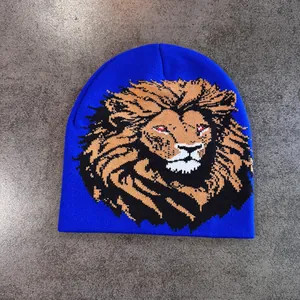 Gros plan du bonnet en tricot bleu avec motif jacquard lion et détails d'yeux rouges