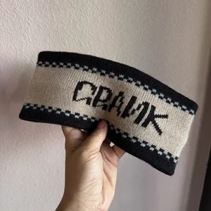 Macro detail of the French jacquard knit texture and Crank letter patterns on the headband