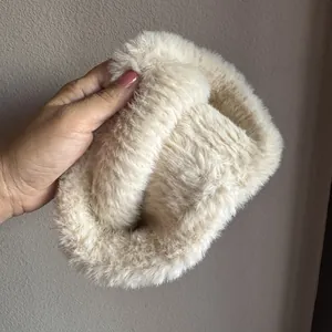 Detail view of plush beige faux rabbit fur headband with soft, fluffy winter texture