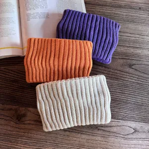 Solid knit headbands in purple, orange, and beige with a thick ribbed texture for winter