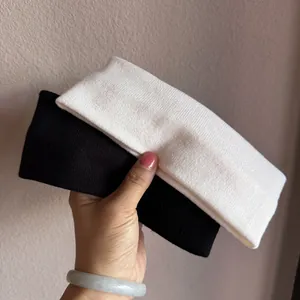 Detail of black and white knitted wide headbands with ribbed texture for sports and makeup