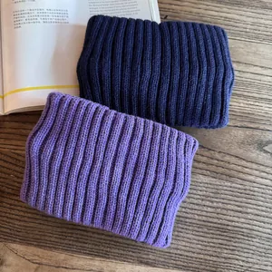 Detailed close-up of chunky ribbed knit texture on navy and purple winter headbands