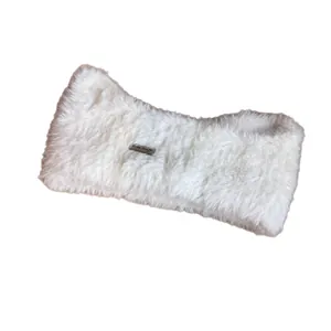 Winter faux fur white headband with plush texture and decorative silver label tag