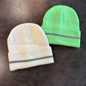 Knit beanies in off-white and neon green with reflective strip and rolled edge design