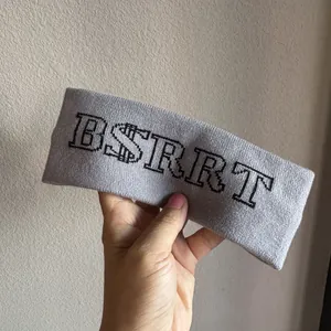 Detail of gray knitted headband showing elastic fabric texture and black BSRRT lettering