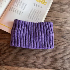 Close-up of purple ribbed knit texture on a wide winter headband for thermal protection