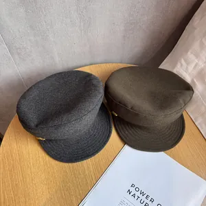 British wool newsboy caps in charcoal and olive green with golden side buttons