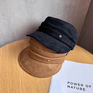 Retro suede baker boy caps in black and brown with metal heart buckle and pleat detail