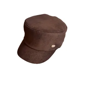 Brown faux suede flat top equestrian cap with a stylish gold metal logo for women