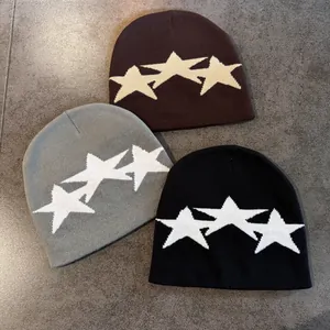 Three minimalist knit beanies with star patterns in brown, grey, and black colors