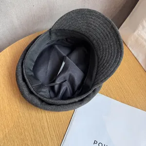 Detail view of newsboy cap interior showing fabric lining and size-adjustable straps