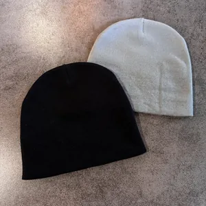 Minimalist knit star beanie set in black and light grey with fine ribbed texture