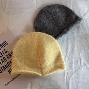 Classic knitted beanies in yellow and dark grey with soft rolled edges for autumn winter