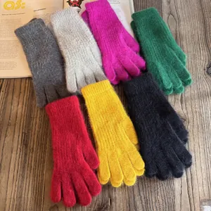 Flat lay of colorful thick winter knit gloves in seven vibrant faux rabbit fur colors
