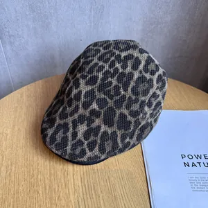 Detailed view of the leopard print knit beret showing premium texture and pattern