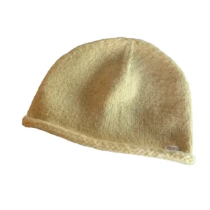 Classic cream knit beanie for women featuring a rolled edge and soft plush mohair texture