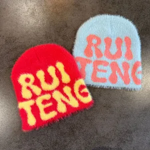 Detailed knit texture of plush faux mink fur beanie with RUI TENG lettering embroidery