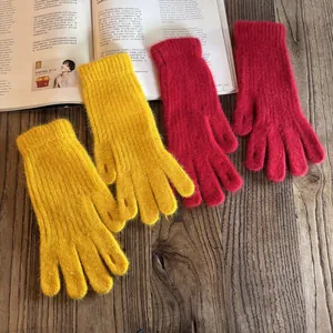 Detail of red rabbit fur knit gloves showing soft texture and ribbed cuff for winter warmth