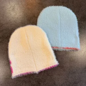 Plush faux mink fur knit beanies in light blue and beige with contrasting edges
