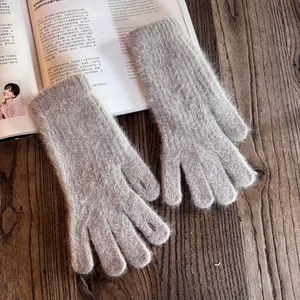 Close-up of deep taupe long-plush knit gloves featuring fuzzy mohair texture and warmth