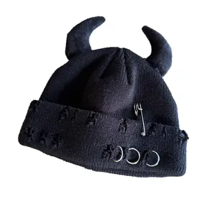 Distressed black beanie with devil horns, silver safety pin and metal rings design