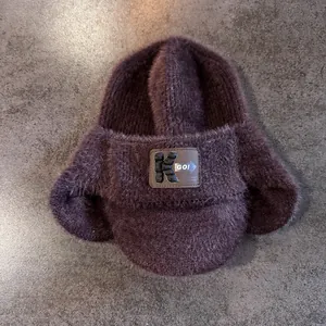 Vue détaillée du bonnet aviateur en peluche marron avec écussons brodés K GO