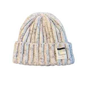 Off-white flecked knit beanie with rolled brim and KAIYAN letter patch for winter warmth
