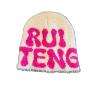 Faux mink fur knitted beanie in beige with pink RUI TENG lettering and ear protection