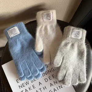 Winter plush knit gloves in blue, white, and gray with soft fur texture and label