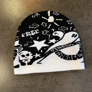 Close-up of knit beanie featuring jacquard skull, stars, and ghost streetwear patterns