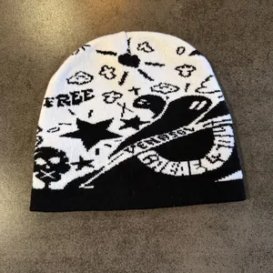 Detail of knitted beanie showing Halloween jacquard patterns with skulls and stars