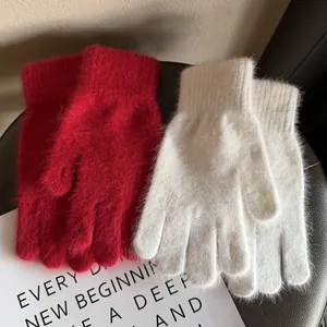 Winter plush knit gloves in red and cream white with soft warm long-hair faux rabbit fur texture
