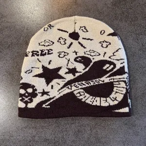 Detail of jacquard knit beanie featuring skull and star patterns in street style