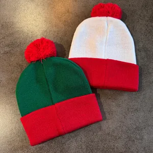 Two-pack Christmas knit beanies in red green and white with plush pom poms for winter warmth