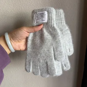 Detail of grey rabbit fur knit glove showing soft texture and decorative woven label