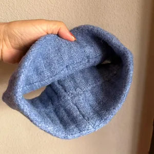 Close-up of sky blue knitted headband showing soft mohair texture and ribbed pattern