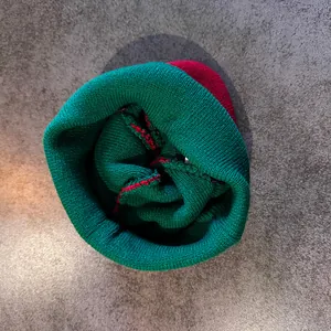 Detailed close-up of heavy-knit stitching and green and red color blocking beanie