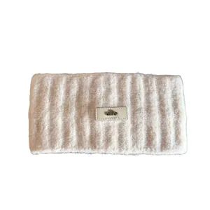 Knitted off-white thermal headband with ribbed texture and leather logo patch