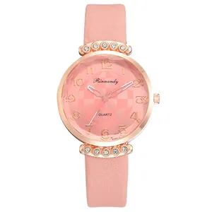 Detailed view of women's pink quartz watch with diamond-studded bezel and leather strap