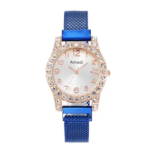 Détail du boîtier en or rose avec strass et bracelet magnétique en maille bleue