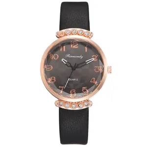Detail of rose gold quartz watch with grey checkered dial and black leather strap