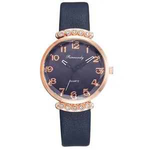 Detail of rose gold case with crystal accents and blue leather strap on quartz watch