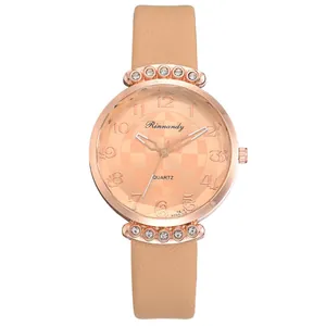 Macro detail of rose gold quartz watch with champagne dial and pink leather strap