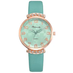 Detail view of mint green leather strap and sparkling crystal lugs on rose gold watch