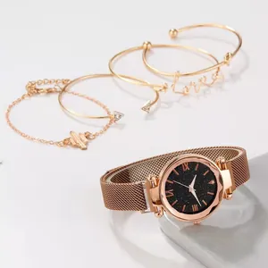 Close-up of rose gold star-themed quartz watch and four elegant bracelets in a 5-piece set