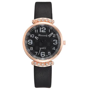 Detail view of the rose gold alloy case and black textured leather strap on this quartz watch