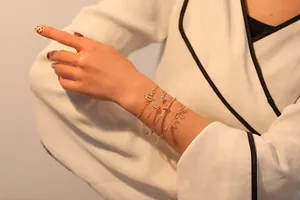Detailed view of 4-piece gold bracelet set with love charm and geometric accents