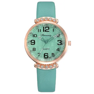 Macro view of mint green leather strap and rose gold rhinestone-encrusted watch case
